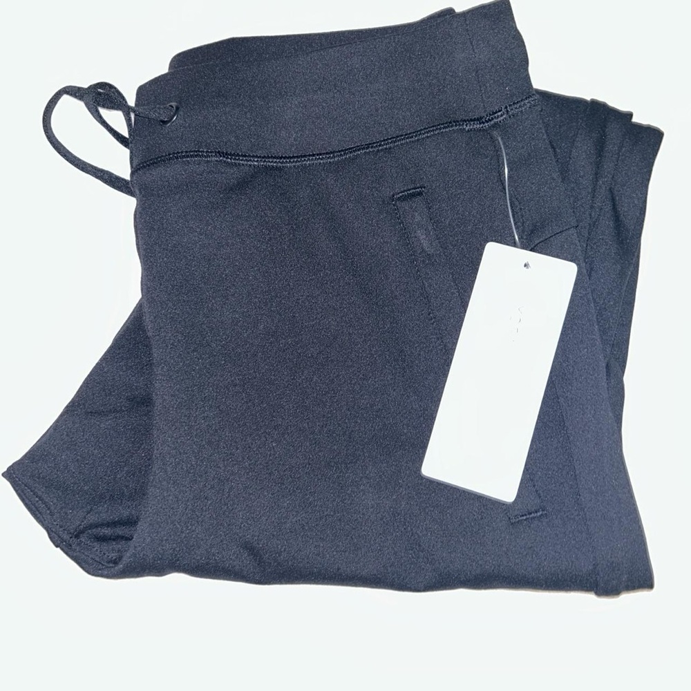 Black yoga cuffed pants with zipper pockets and a jawstring!